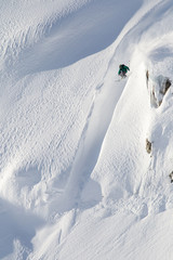 A skier jumps of a huge cliff in Whistler, British Columbia