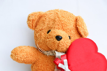 Cute Teddy bear with red heart symbol on white background
