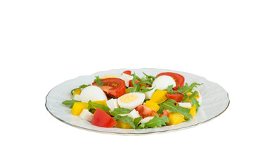 Vegetable salad on a plate on a white background.