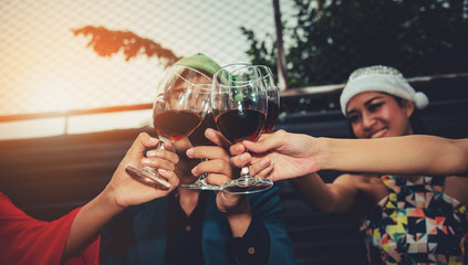 Group of Friends Enjoying Cheerful Party and Clinking Glass of Wine at Rooftop Nightclub