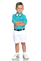 A beautiful little boy in a shirt and shorts