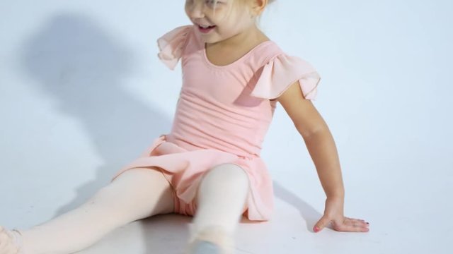 A small ballerina dances with enthusiasm. The girl is engaged in ballet