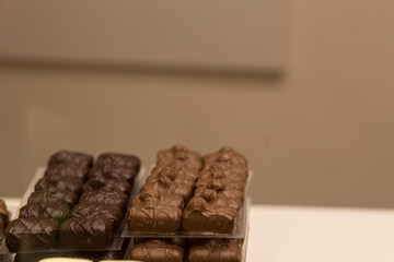Belgium tasty truffle delicious chocolate in a row, candy shop view. Food travel tourism.
