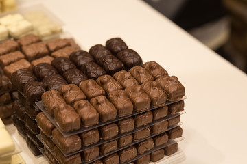 Belgium tasty truffle delicious chocolate in a row, candy shop view. Food travel tourism.