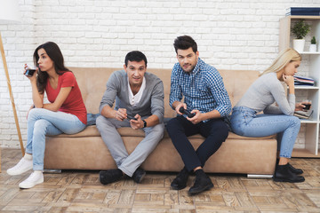 Two guys and two girls play on the game console.
