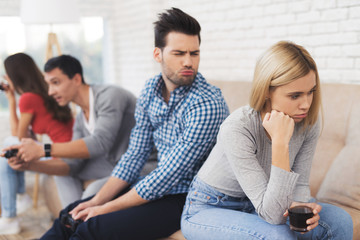 Two guys and two girls play on the game console.