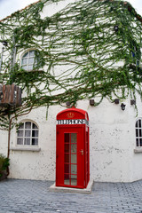 Fototapeta premium Red phone box with new technology