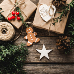 Christmas background with gingerbread, xmas tree and decoration on dark wooden board.