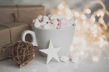 Obraz na płótnie Canvas Cup of hot chocolate and marshmallow in the background of Christmas decorations.