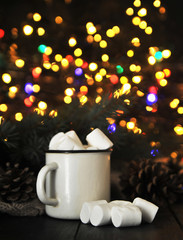 Cup of cacao with a marshmallows on a wooden background 
