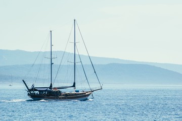 Sailboat on blue sea background