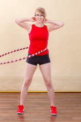 Fit woman with hula hoop doing exercise