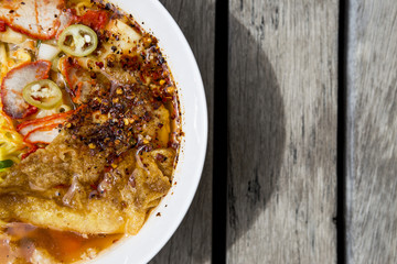 Closeup Thai style spicy egg noodle soup with roasted pork