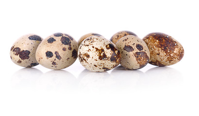 Quail eggs close up isolated on white background.
