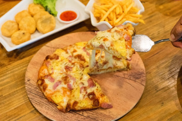 pizza put on wooden plate