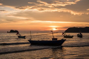 Fototapeta na wymiar Sunset with Fisherman ships