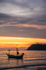 Naklejka na ściany i meble Sunset with Fisherman ships