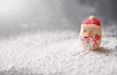 Snowman cookies in snow.
