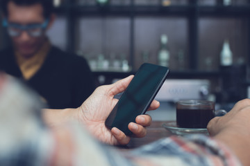 Man using smartphone at coffee shop