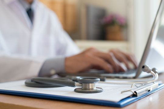 Docter working on laptop computer