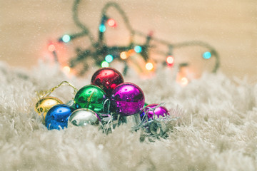 Christmas ball on carpet with snow and colorful bokeh light background