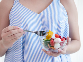 Pregnant woman eating healthy fresh salad,healthy nutrition during pregnancy