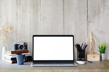 Modern and stylish workspace with laptop computer, office supplies, books, retro camera at home or...