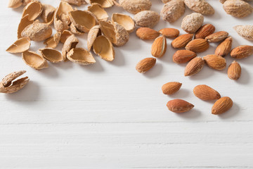 salted almonds in shell on wooden background