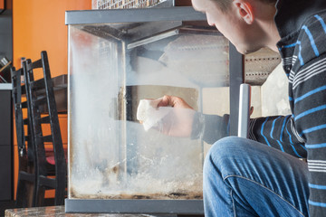 Man wipes the dirty glass of fireplace