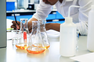 Young scientist experiment chemical research in science classroom and laboratory. 