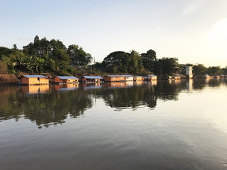 Fototapeta na wymiar Houseboat floating on surface river beautiful landscape attractions in Thailand.