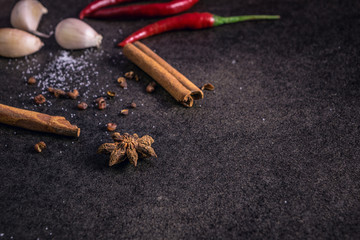 Herbs and spices over black stone background, mystic photography,  selective focus and dark background