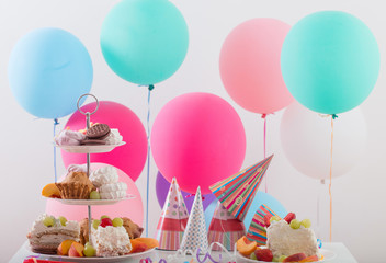 Birthday celebration with cake and colorful balloons