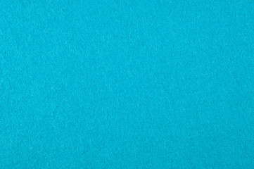 Background texture, pattern. Woolen fabric is turquoise. Felt. Close up view of a turquoise fabric texture and background. Abstract background and texture for designers.
