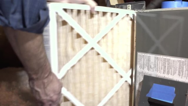 homeowner replacing the whole house air conditioning filter in attic 4k