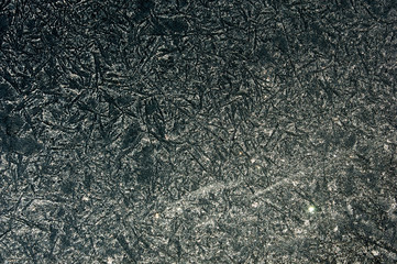Fototapeta na wymiar Texture, background, pattern. Frosty pattern on the glass. Macro shot from Snowflake. Abstract winter background. This is frosty pattern on glass winter window.