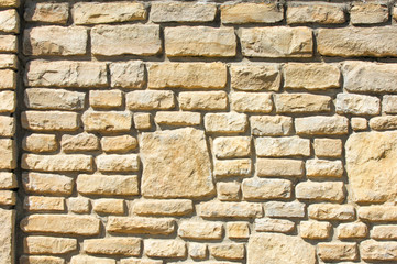 Texture background, pattern. The wall is stone. Architecture. Construction, house fencing. Sandstone cobbles