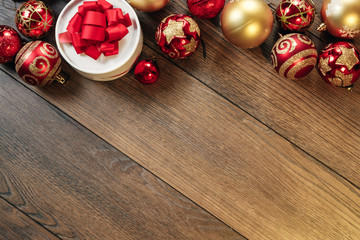 Christmas ornaments and gifts on a wooden table. Holidays christmas background. Copy space for text or design. View from above.