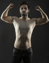 Fototapeta na wymiar Caucasian guy with fit slim body isolated inside studio
