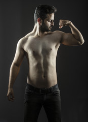 Fototapeta na wymiar Caucasian guy with fit slim body isolated inside studio