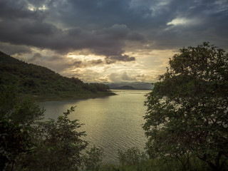Evening Light at a lake in Phetchaburi, Thailand. Sunset, Twilight Sky with colourful on background.