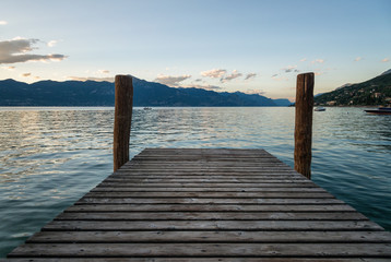 Fototapeta premium Wooden pier on Garda lake at sunset