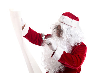 Portrait of Santa Claus using magnifying glass to reading big letter attentive isolated on white background.