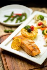 Grilled Salmon with garlic and herb ,lemon isolated on white plate