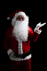 Christmas Santa Claus showing empty copy space on the open hand palm for text.