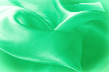 Texture, background, pattern. Green silk fabric for draping. Abstract Fabric, Artistic Waving Cloth...