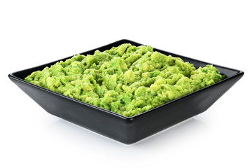 Bowl with guacamole isolated on white background.
