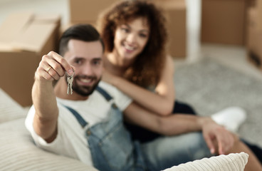 Young couple with a key to a new apartment.