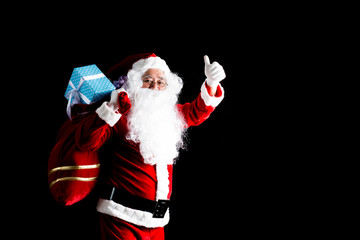 Santa Claus carries a bag with gifts. Isolated on white background.