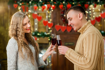 husband and wife celebrate valentine's day. they hugging, smiling and drinking champagne. Concept of happy valentine's day